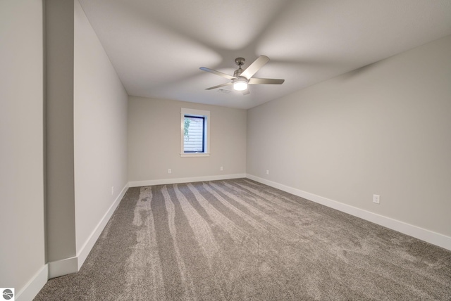 unfurnished room featuring carpet flooring, baseboards, and ceiling fan