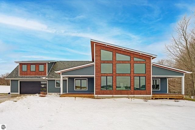 view of front of house featuring a porch, a garage, and a shingled roof