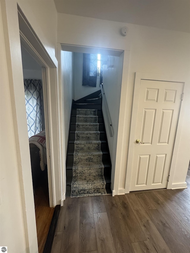 stairs featuring hardwood / wood-style flooring