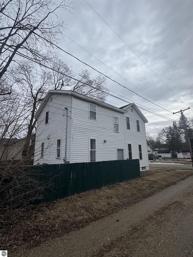 view of home's exterior featuring fence