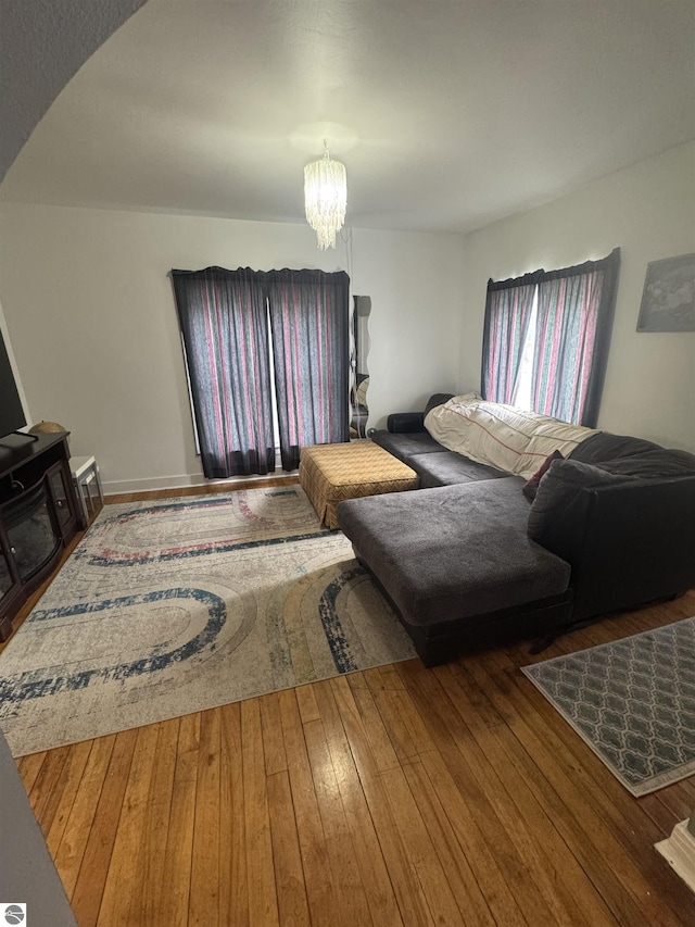 living area featuring wood-type flooring and a chandelier