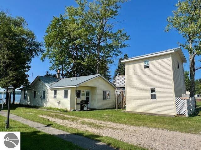 rear view of property with a lawn