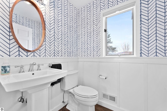 bathroom with visible vents and toilet