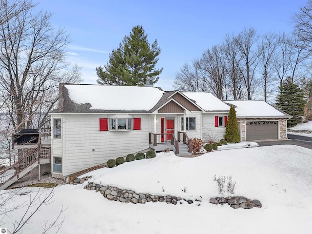 single story home with aphalt driveway and an attached garage