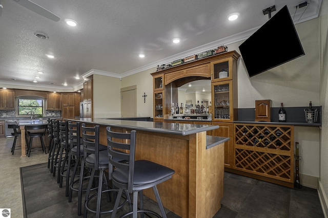 bar with ornamental molding, visible vents, a bar, and dishwashing machine