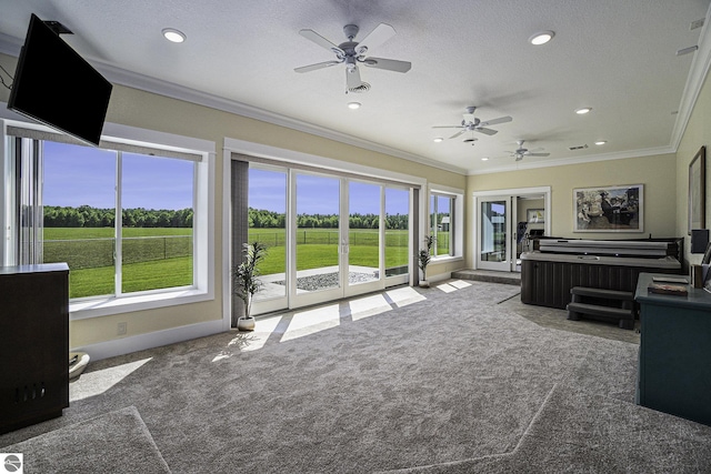 unfurnished living room featuring crown molding and plenty of natural light