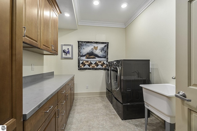 laundry room with cabinet space, baseboards, crown molding, separate washer and dryer, and recessed lighting