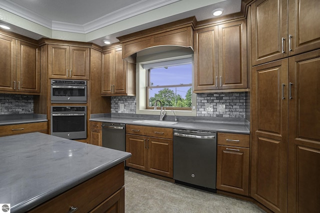 kitchen featuring decorative backsplash, ornamental molding, stainless steel appliances, and a sink