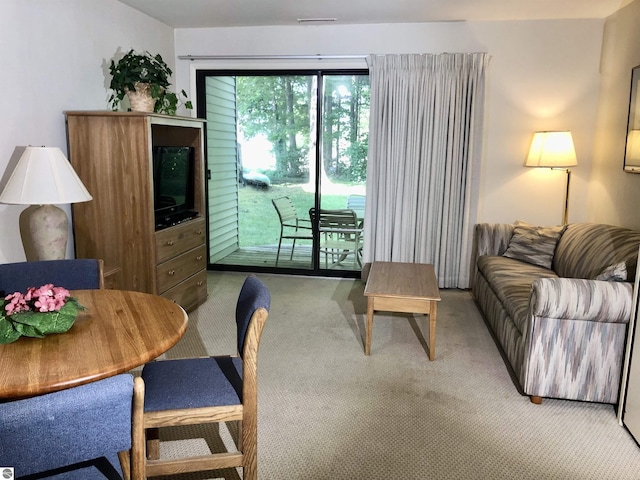 living room with visible vents and light colored carpet