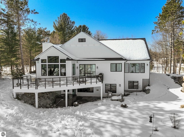 snow covered house with a chimney