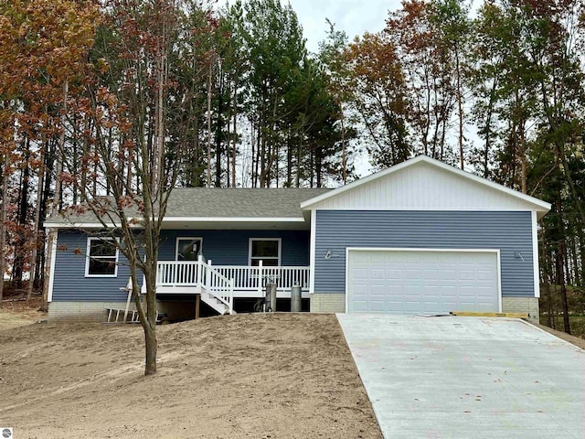 ranch-style house with a garage, concrete driveway, a porch, and a shingled roof