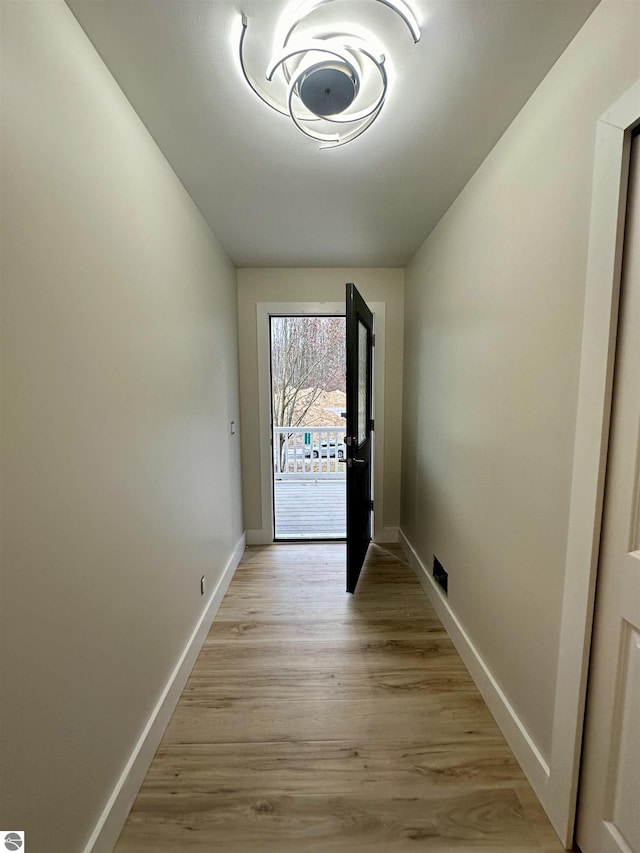 entryway with light wood-type flooring, visible vents, and baseboards