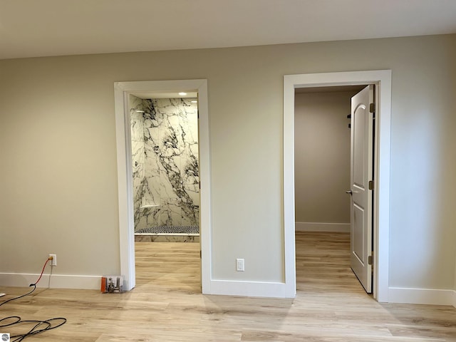 interior space featuring light wood-style flooring and baseboards