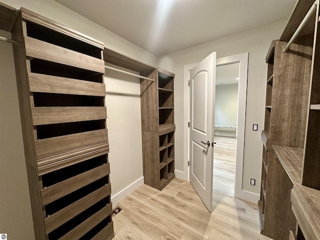 spacious closet with wood finished floors