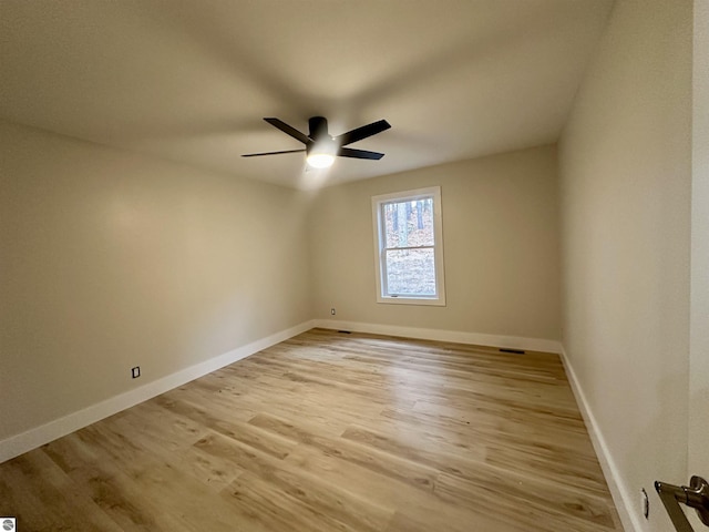 spare room with light wood-style flooring, baseboards, and a ceiling fan