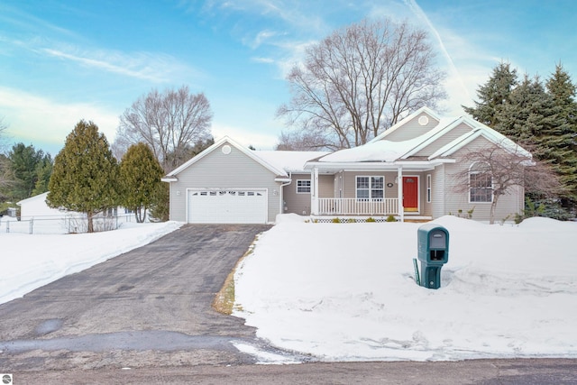 ranch-style home featuring a garage, aphalt driveway, fence, and a porch