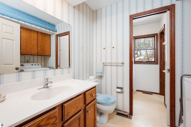 bathroom featuring wallpapered walls, baseboards, visible vents, toilet, and vanity