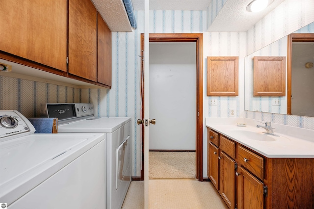 clothes washing area featuring laundry area, independent washer and dryer, a sink, and wallpapered walls