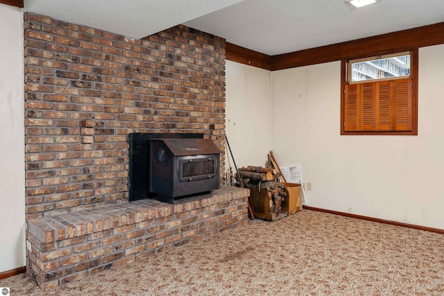 interior space featuring a textured ceiling, carpet flooring, a wood stove, and baseboards