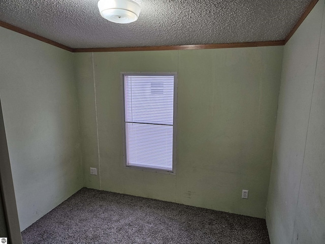 unfurnished room with carpet floors, ornamental molding, and a textured ceiling