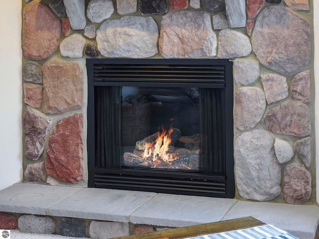 interior details with a lit fireplace