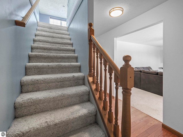 stairs with wood finished floors