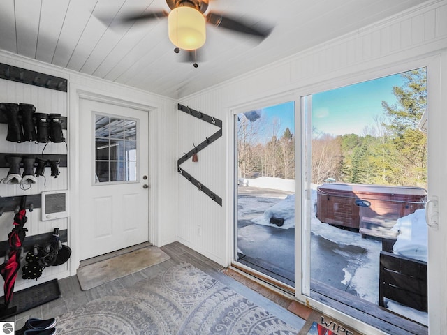 entryway featuring ornamental molding, wood finished floors, a ceiling fan, and heating unit