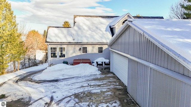 view of snow covered back of property