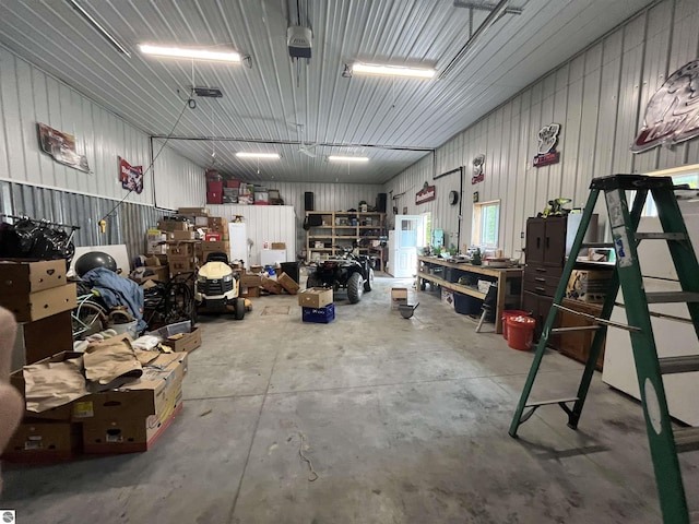 garage featuring a workshop area and metal wall