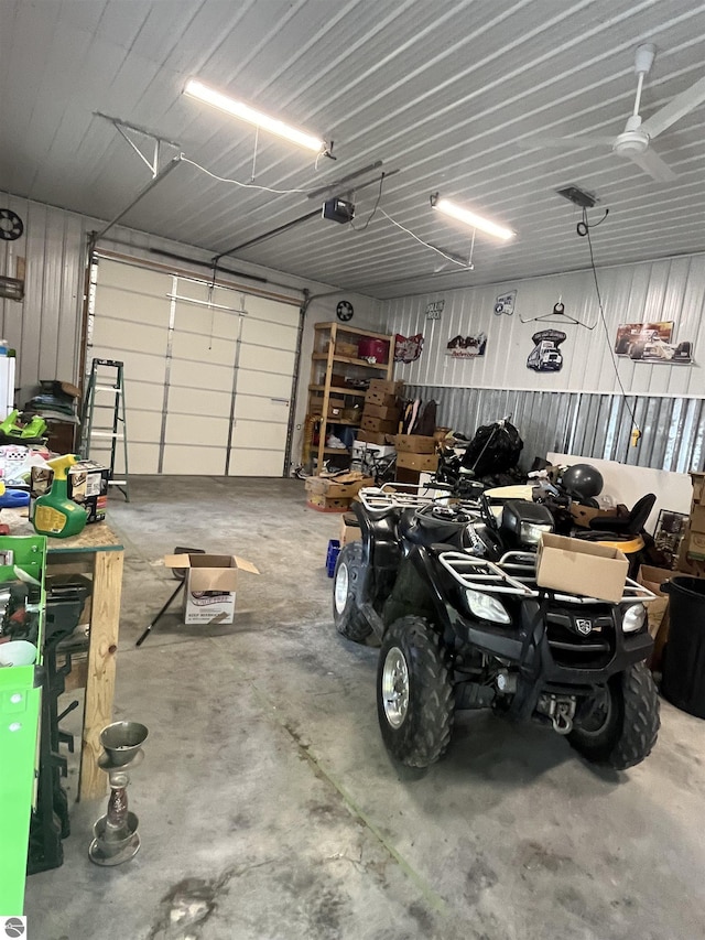 garage featuring metal wall and a garage door opener