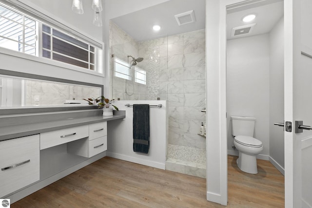 full bath featuring wood finished floors, visible vents, toilet, and walk in shower