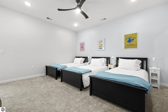 bedroom featuring baseboards, visible vents, and light colored carpet