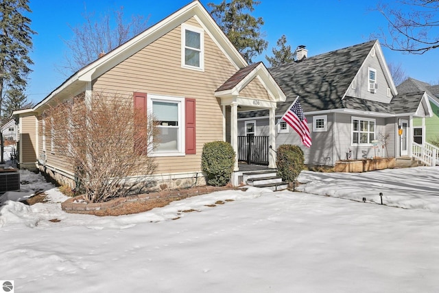 view of front of property featuring a chimney and cooling unit