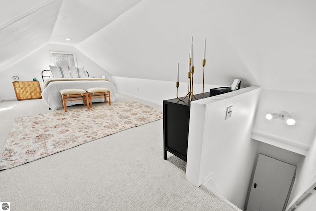 carpeted bedroom with lofted ceiling