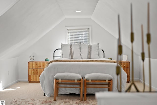 bedroom with carpet, baseboards, and vaulted ceiling