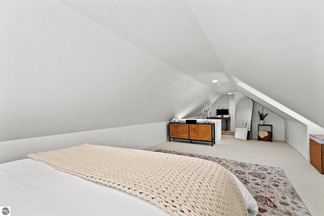 bedroom with lofted ceiling and carpet floors