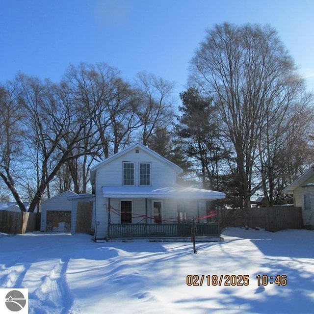 view of front of home with covered porch and fence