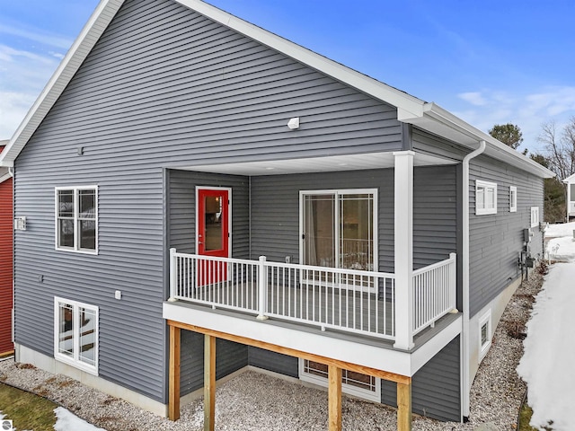 back of property with covered porch