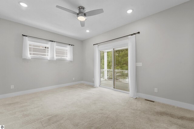 carpeted empty room with ceiling fan, recessed lighting, visible vents, and baseboards