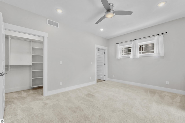 unfurnished bedroom featuring baseboards, visible vents, a spacious closet, carpet flooring, and recessed lighting