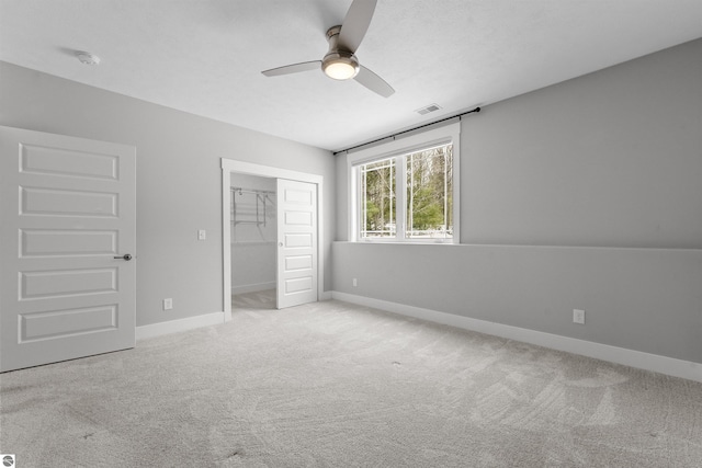 unfurnished bedroom featuring a closet, carpet flooring, visible vents, and baseboards