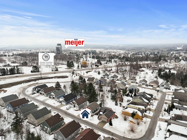 snowy aerial view featuring a residential view