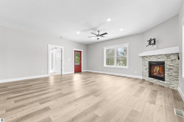 unfurnished living room with visible vents, baseboards, light wood-style flooring, a fireplace, and recessed lighting