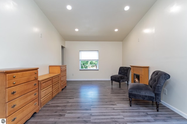 living area with recessed lighting, baseboards, and wood finished floors