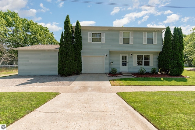 colonial house with an attached garage, driveway, a front yard, and entry steps