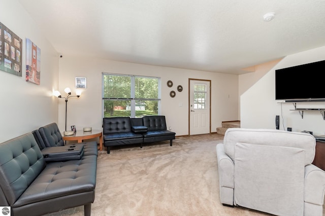 living room with carpet floors and stairs