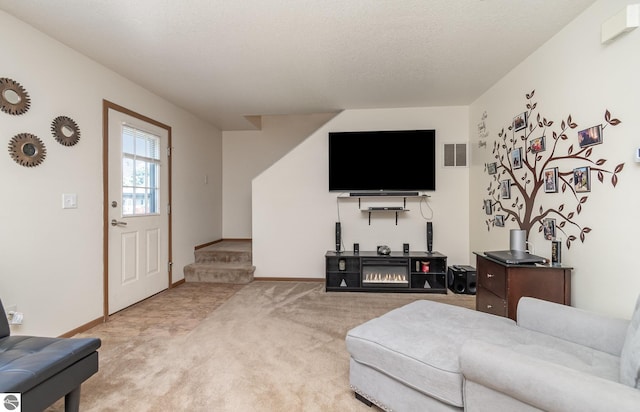 living area featuring a textured ceiling, light carpet, visible vents, baseboards, and stairs