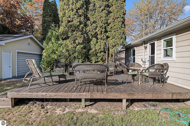 wooden deck with a garage and an outdoor structure