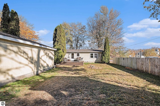 view of yard with fence and a deck