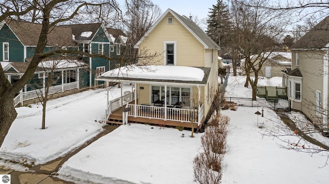 view of front facade with a residential view and fence